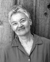 Woman with short white hair.