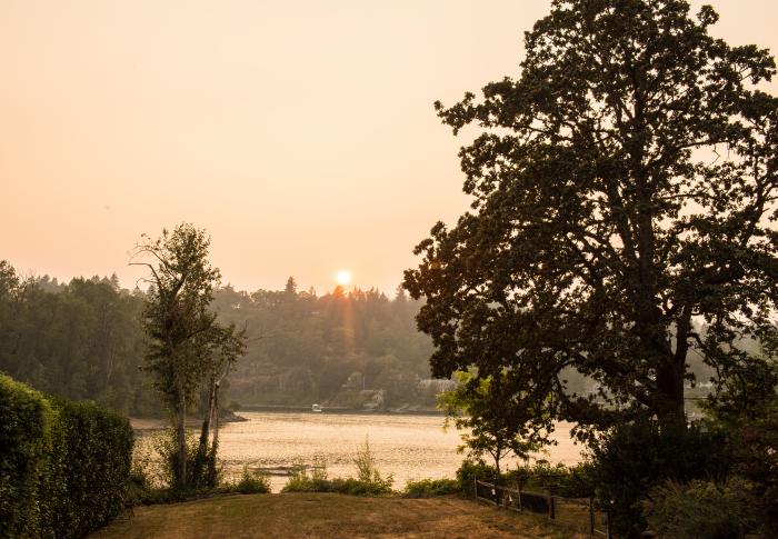 A smoky view of the Willamette River near Milwaukie. The sun is visibly dimmed by the smoke. 