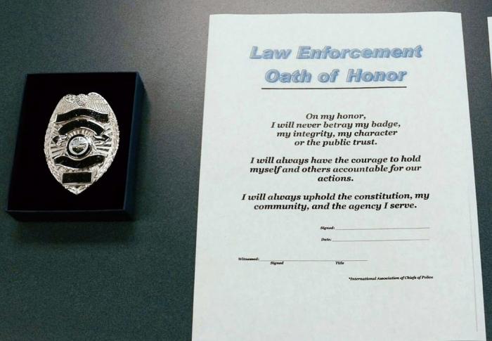 photo of badge and oath of honor document