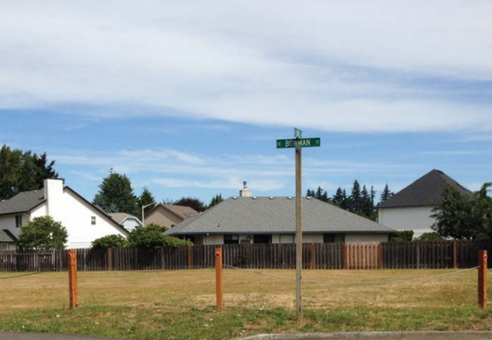 grassy field behind fence