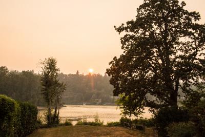 A smoky view of the Willamette River near Milwaukie. The sun is visibly dimmed by the smoke. 