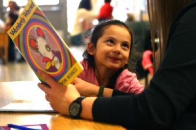 adult reading a book to a kid