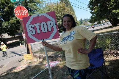 Carefree Sunday volunteer holding a stop sign