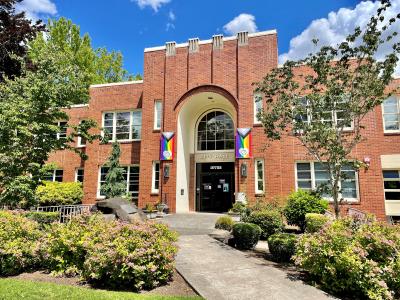 Front of Milwaukie City Hall with festive Pride-themed banners